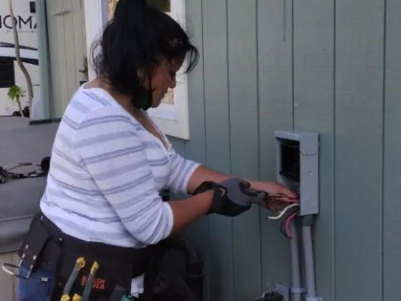 Licensed electrician wiring an exterior subpanel in Mapleton
