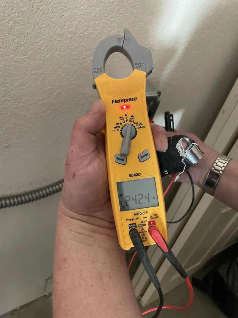 Voltage testing with clamp meter during Recessed Lighting Installation in Mapleton